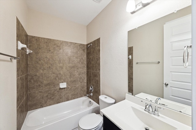 full bathroom with vanity, tiled shower / bath combo, and toilet