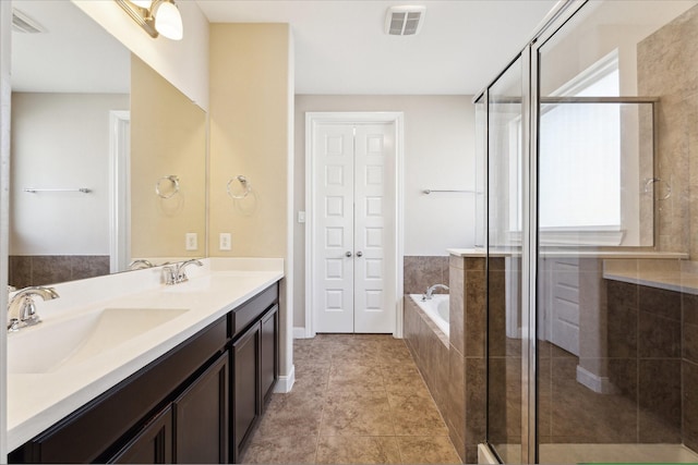 bathroom with vanity and shower with separate bathtub