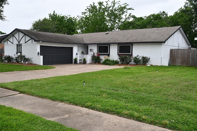 view of front of home with a front lawn and a garage