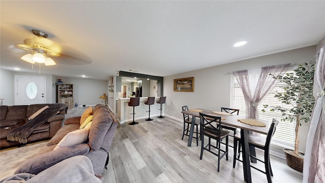 living room featuring ceiling fan and light hardwood / wood-style floors