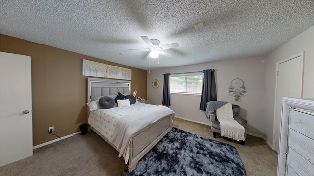 bedroom featuring ceiling fan, light carpet, and a textured ceiling