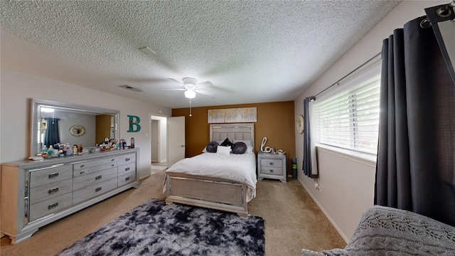 carpeted bedroom with a textured ceiling and ceiling fan