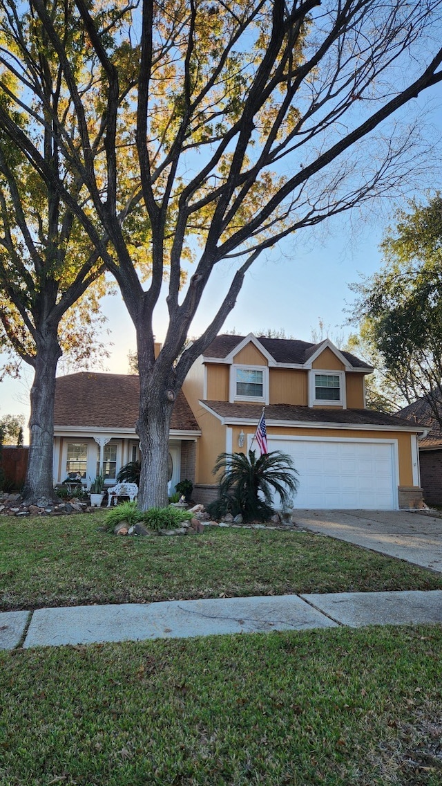 view of front of home with a garage and a front lawn