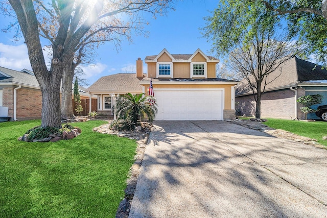 traditional-style home with a front yard, concrete driveway, a chimney, and an attached garage