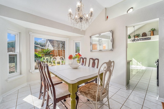 dining space with light tile patterned flooring, vaulted ceiling, and a wealth of natural light