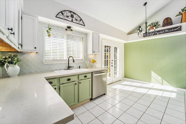 kitchen with lofted ceiling, sink, dishwasher, tasteful backsplash, and green cabinetry