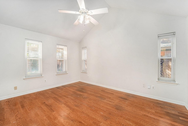 empty room featuring lofted ceiling, hardwood / wood-style floors, and ceiling fan