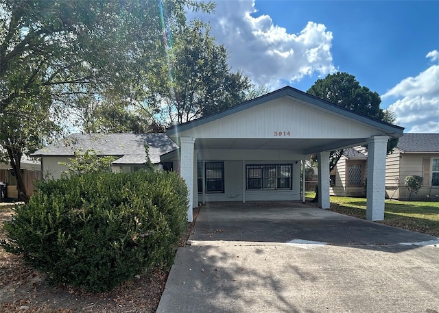 view of front of property featuring a carport