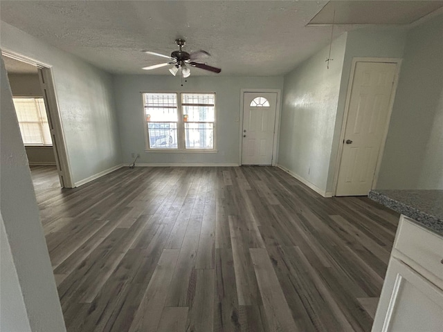 entryway with dark hardwood / wood-style floors, ceiling fan, a textured ceiling, and a wealth of natural light