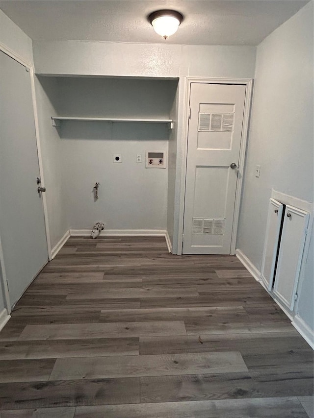 washroom with dark hardwood / wood-style flooring, washer hookup, and hookup for an electric dryer