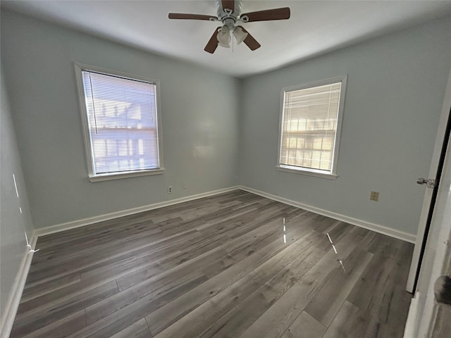 unfurnished room with dark hardwood / wood-style flooring and ceiling fan