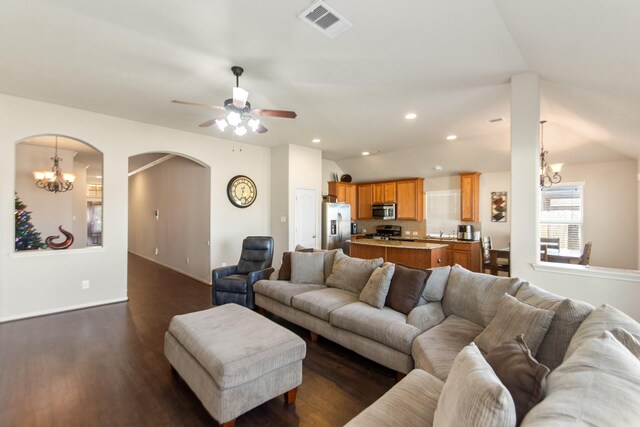 living room with ceiling fan, dark hardwood / wood-style flooring, and lofted ceiling