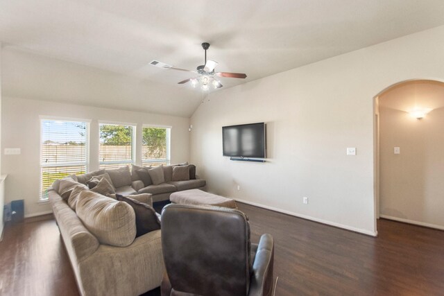 living room featuring vaulted ceiling, ceiling fan, and dark wood-type flooring