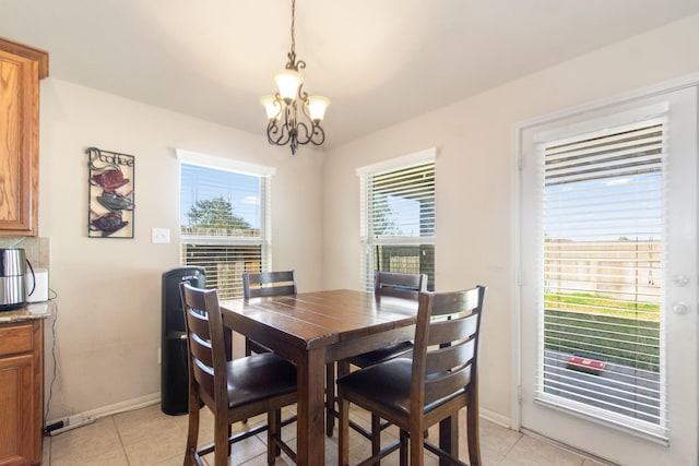 tiled dining space featuring a notable chandelier