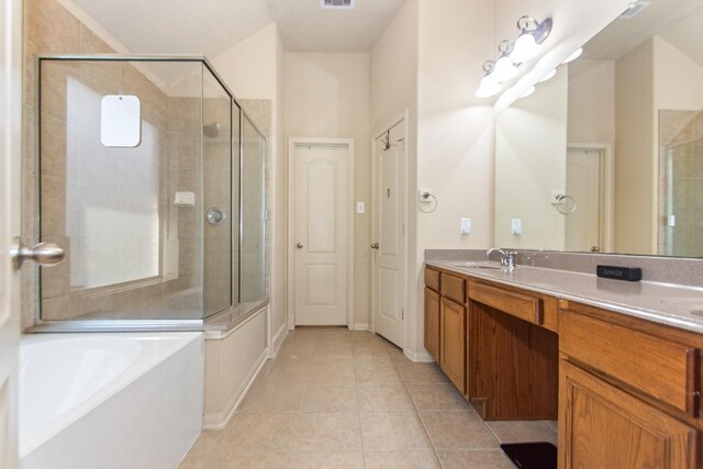 bathroom with tile patterned floors, vanity, and shower with separate bathtub