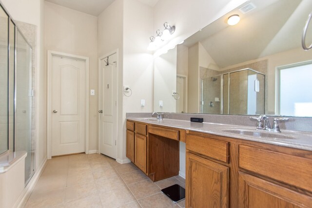 bathroom featuring tile patterned floors, vanity, and walk in shower