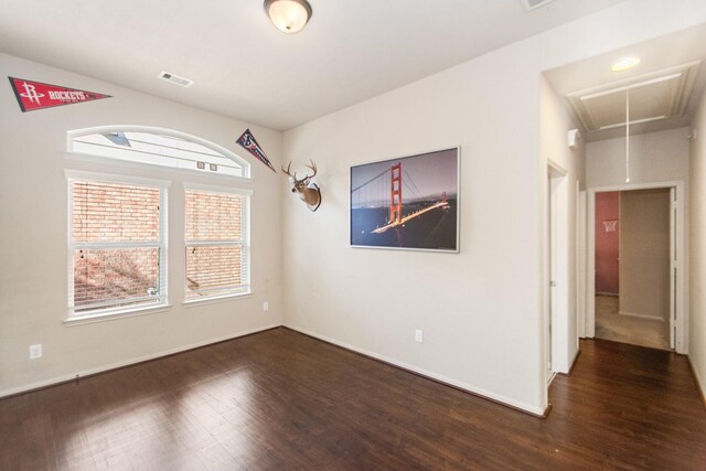 unfurnished room with dark hardwood / wood-style flooring