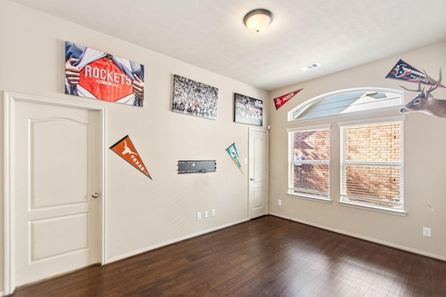 spare room featuring dark wood-type flooring