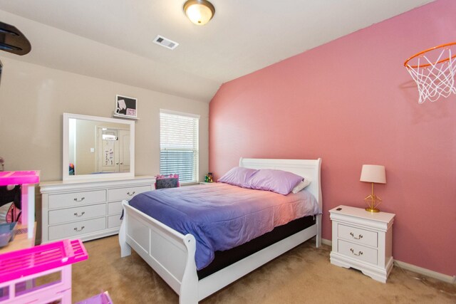 carpeted bedroom with lofted ceiling