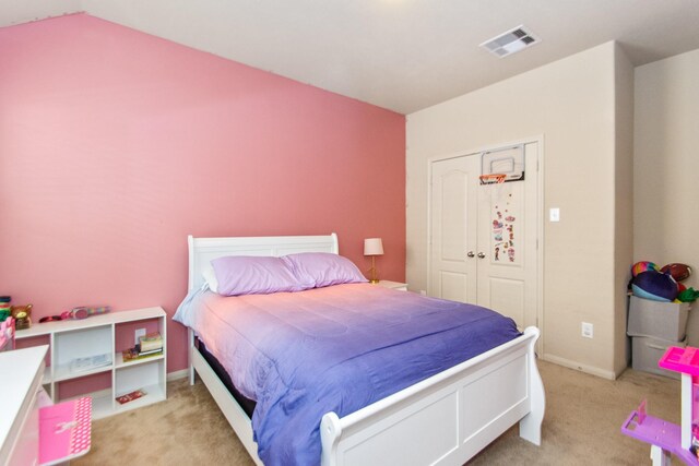 bedroom featuring light carpet and vaulted ceiling