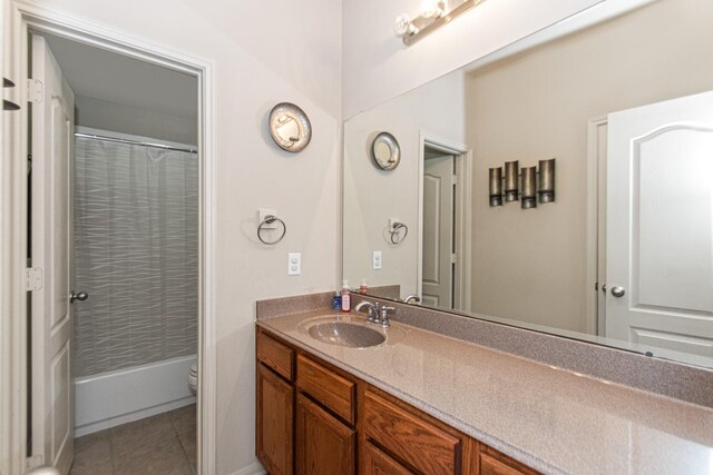 bathroom with tile patterned flooring, vanity, and toilet