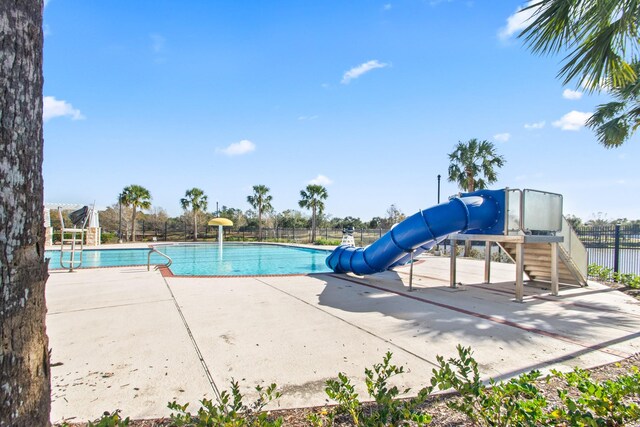 view of pool with a water slide