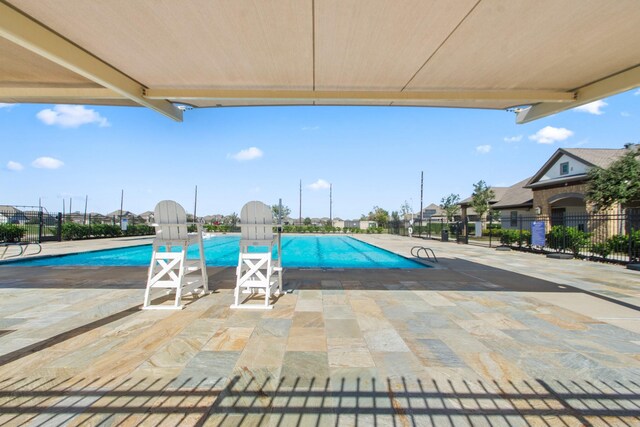 view of swimming pool featuring a patio area