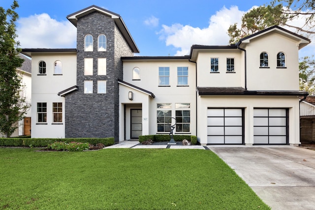 view of front of property featuring a garage and a front lawn