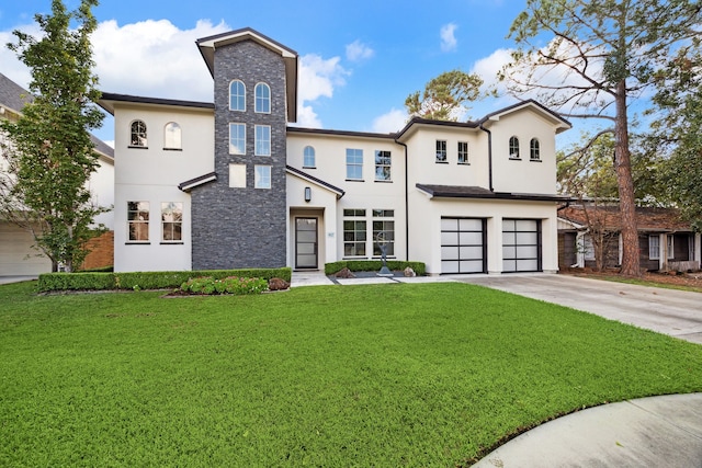 view of front of home with a garage and a front lawn