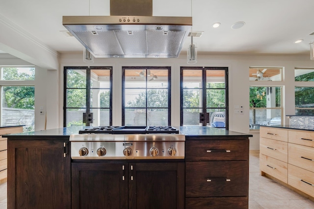 kitchen featuring dark brown cabinets, crown molding, exhaust hood, light tile patterned floors, and stainless steel gas stovetop