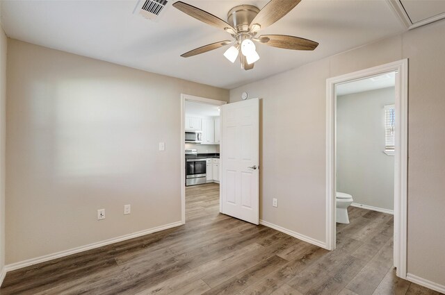 spare room with hardwood / wood-style flooring and ceiling fan