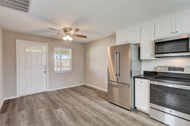 kitchen featuring ceiling fan, white cabinetry, appliances with stainless steel finishes, and light hardwood / wood-style flooring