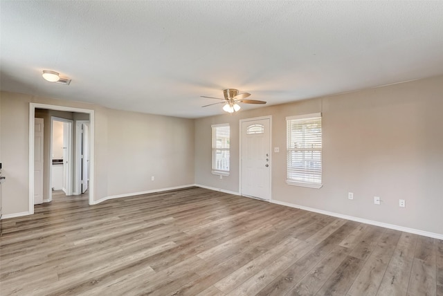 interior space with ceiling fan and light wood-type flooring