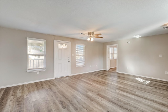 interior space with a healthy amount of sunlight, ceiling fan, and light hardwood / wood-style flooring