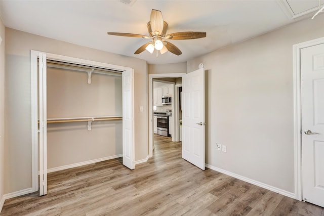 unfurnished bedroom with ceiling fan, a closet, and light wood-type flooring