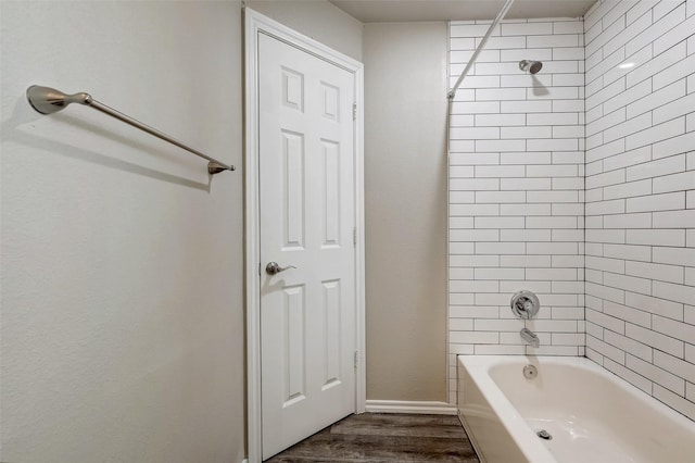 bathroom featuring tiled shower / bath combo and wood-type flooring