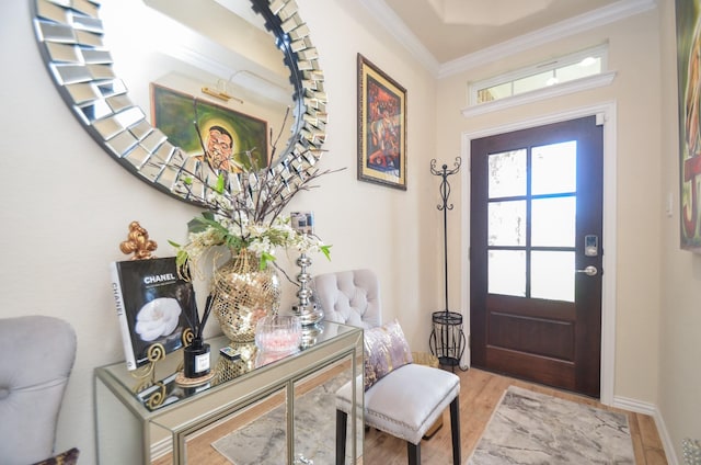 entryway with wood-type flooring and ornamental molding