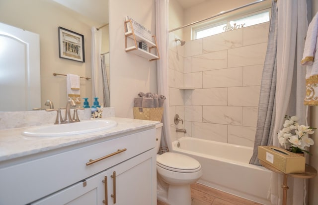 full bathroom featuring shower / tub combo, vanity, and toilet