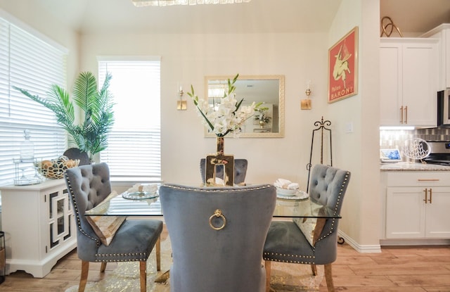 dining space with light hardwood / wood-style flooring