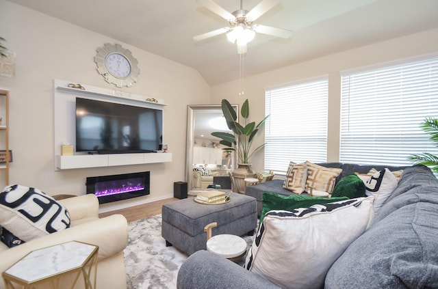 living room featuring ceiling fan, light wood-type flooring, and lofted ceiling