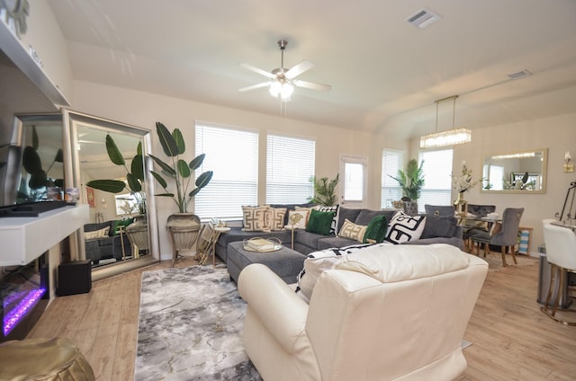 living room with ceiling fan and light hardwood / wood-style floors