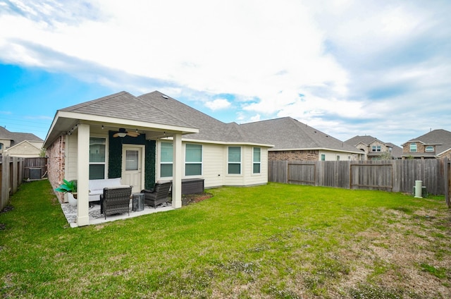 back of house featuring a lawn, a patio area, and ceiling fan