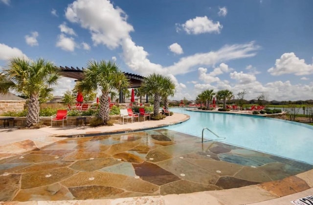 view of swimming pool with a patio area