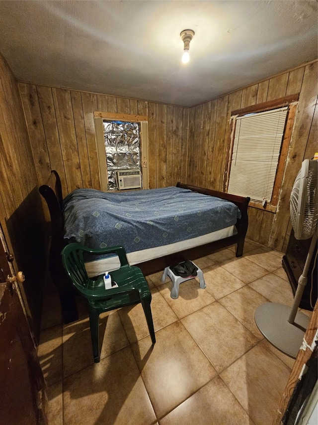 bedroom featuring tile patterned floors, cooling unit, and wood walls