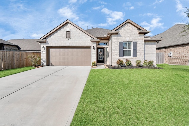 view of front of house with a garage and a front lawn