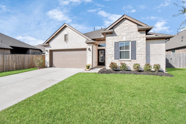 view of front of property featuring a front yard and a garage