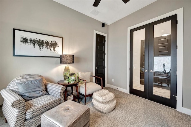 sitting room featuring carpet flooring, french doors, and ceiling fan