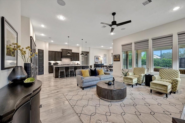 living room with light hardwood / wood-style floors and ceiling fan