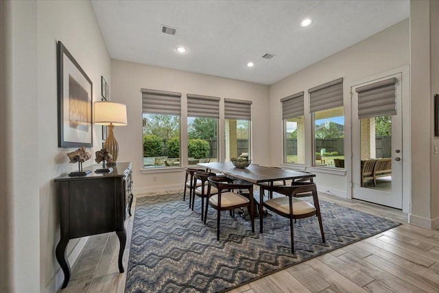 dining space with hardwood / wood-style floors