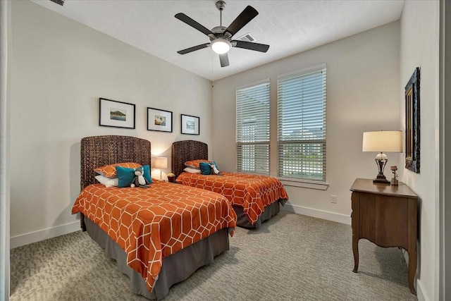 bedroom featuring ceiling fan and light carpet